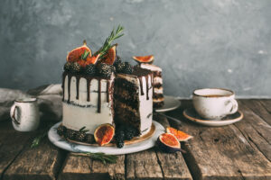 Delicious chocolate cake with figs and blackberries on a rustic background